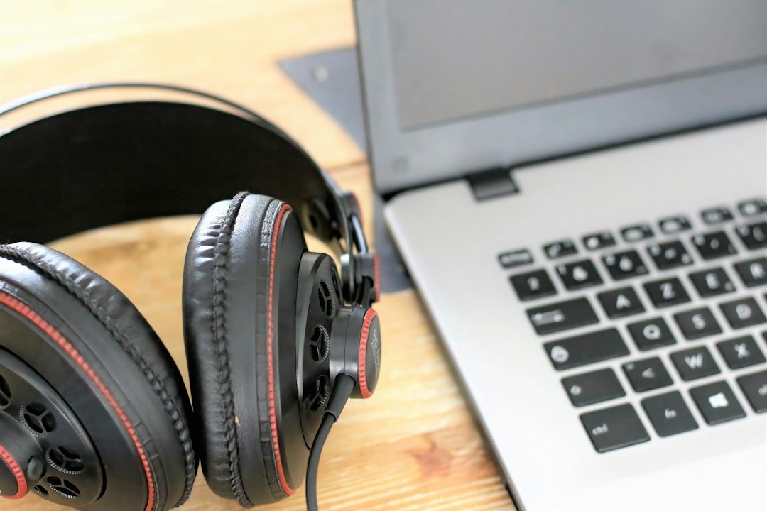 USB headphones resting on a Windows 11 laptop, showing the USB audio Code 10 problem